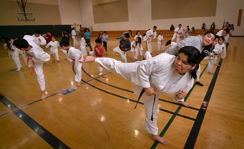 Carolina Garcia, 16, front center, participates in with the rest of his class during a Anaheim Police Activities League/Cops 4 Kids karate class. Photo by Steven Georges/Behind the Badge OC