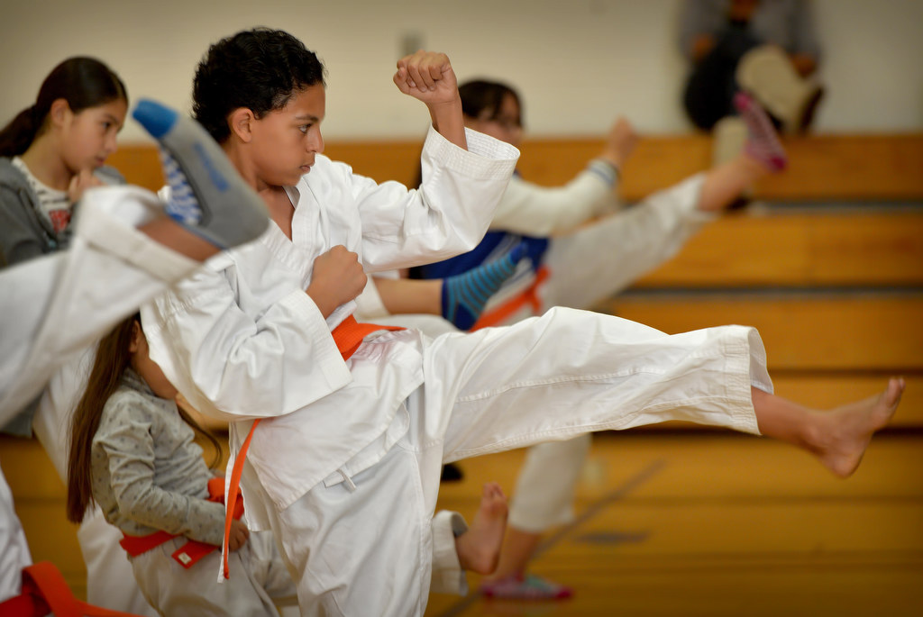 Ahmed Mohamad, 11, participates in kicks with the rest of his class during a Anaheim Police Activities League/Cops 4 Kids karate class. Photo by Steven Georges/Behind the Badge OC