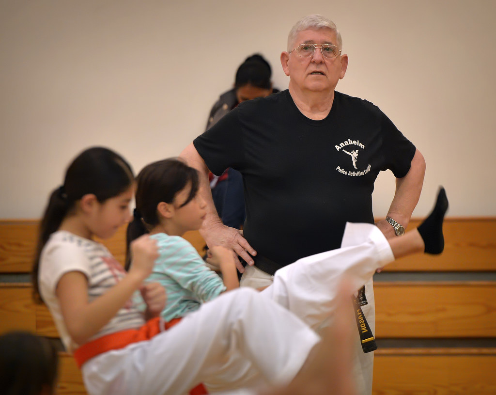 Fred Mason, Anaheim Police Activities League/Cops 4 Kids karate instructor, keeps an eye on the kids during class. Photo by Steven Georges/Behind the Badge OC