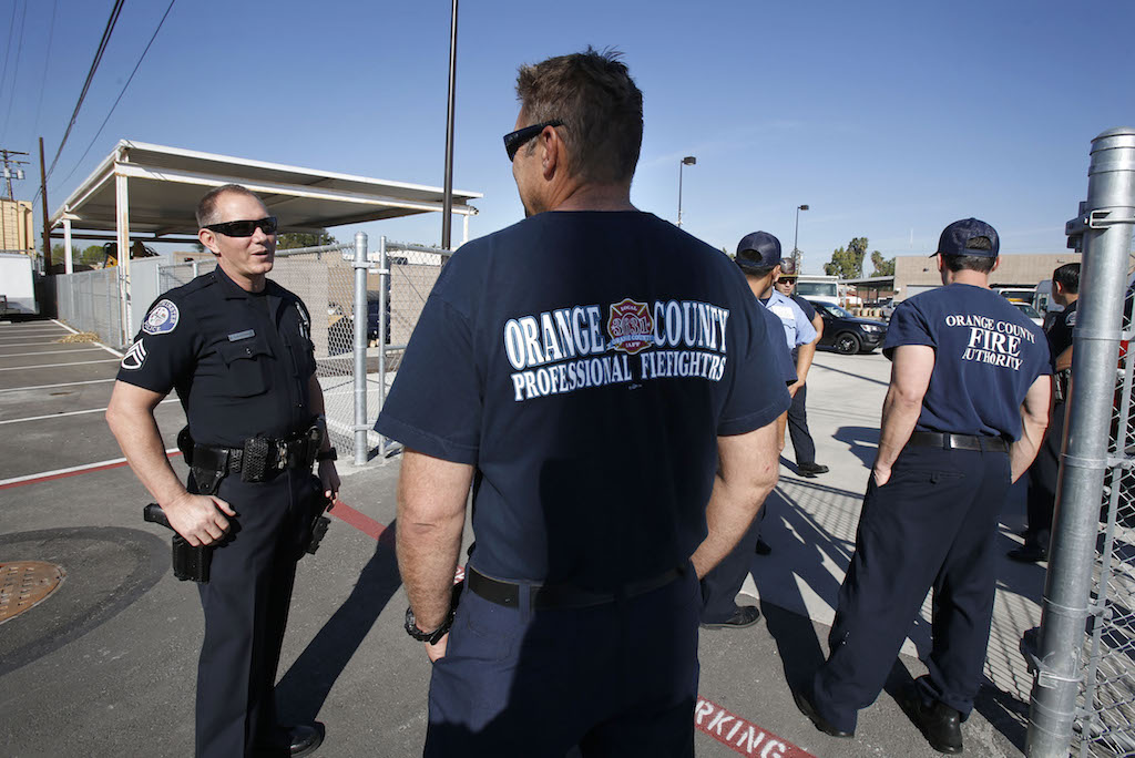 Westminster Police Department Sgt. Mark Lauderback, left,  works with the OC Fire Authority in preparation during an active shooter drill. Photo by Christine Cotter