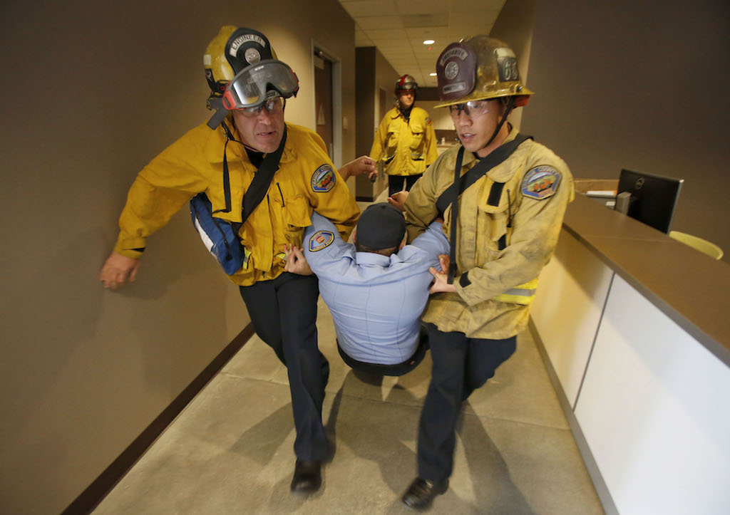 OC Fire Authority members aid a "victim" during an active shooter drill in conjunction with the Westminster Police Department. Photo by Christine Cotter