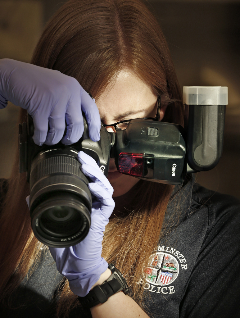 Photography skills are some of the most important attributed forensic technicians bring to a police department. Taking accurate photographs helps detectives reference the scene throughout their investigation.  Photo by Christine Cotter