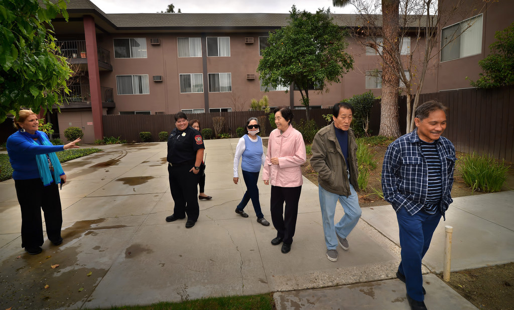 Residents of Miracle Terrace in Anaheim respond to the alarm of a fire drill as they walk to the community room for an education talk on being prepared. Photo by Steven Georges/Behind the Badge OC