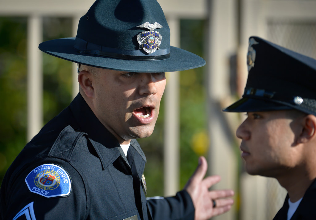 Garden Grove PD Officer Nick Jensen, left, addresses Garden Grove PD Recruit Phillip Pham during a drill session at GGPD headquarters. Photo by Steven Georges/Behind the Badge OC