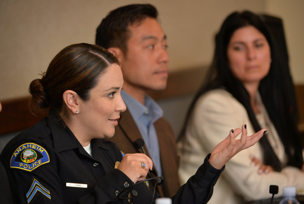Anaheim PD Detective Laura Lomeli participates in a discussion on detective work at the Anaheim Public Library. Behind her is Anaheim PD Detective Long Cao and Civilian Investigator Mari Aborqui, right. Photo by Steven Georges/Behind the Badge OC
