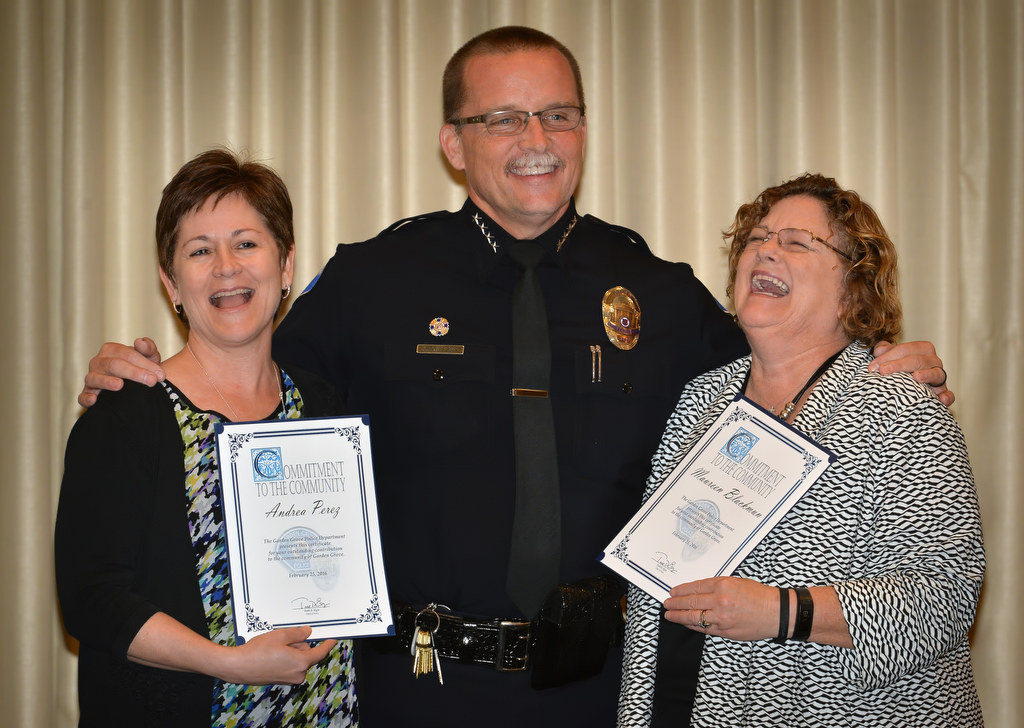 (10:20) Andrea Perez, left, and Maureen Blackmun, (Blackman?) right, receive their GGPD chief’s coin award from Garden Grove Police Chief Todd Elgin for their work in the Neighborhood Watch program. Photo by Steven Georges/Behind the Badge OC