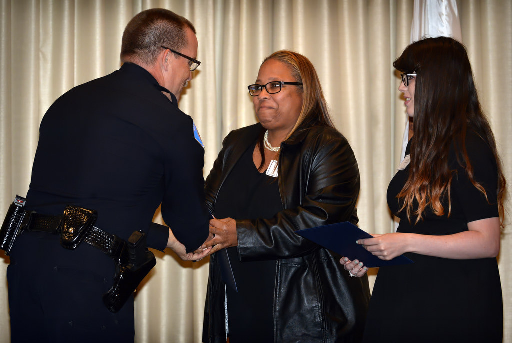 (26:25) Michelle Stringer, center, and Jessica La Combe receive their GGPD chief’s coin award from  Garden Grove Police Chief Todd Elgin for their work in acquiring several hundred stuffed toys donated by others for the GGPD to give to Military and low income families for Christmas. Photo by Steven Georges/Behind the Badge OC