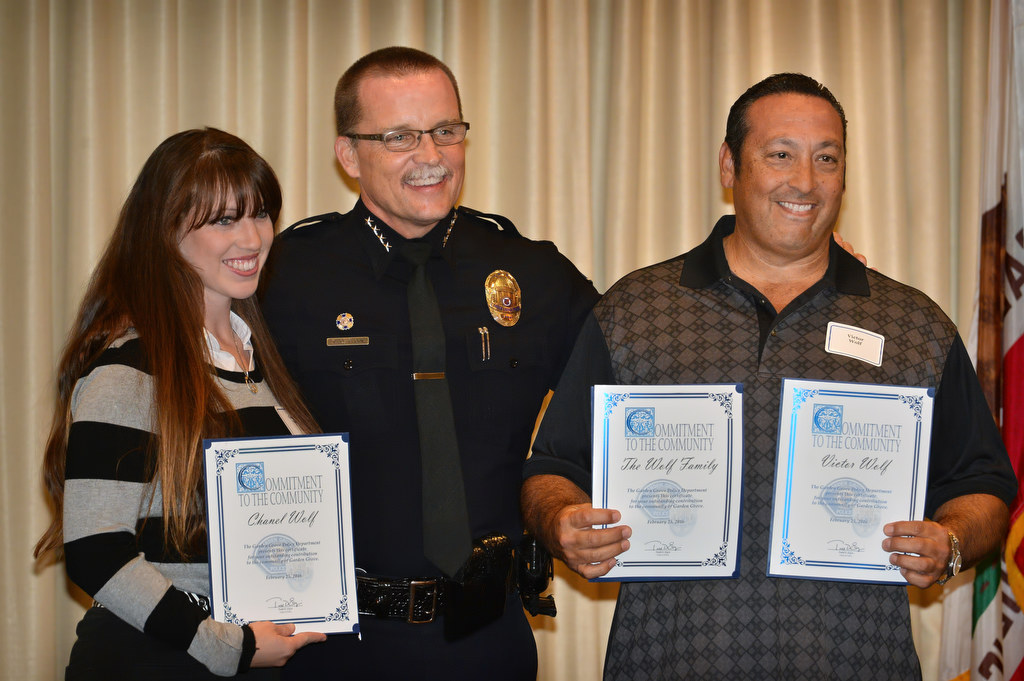 (54:40) Chanel Wolf, left, and Victor Wolf receive their chief’s coin awards from Garden Grove Police Chief Todd Elgin for not one, but two separate acts of heroism. The first incident is for their help saving lives during a neighbors house fire and a second coin for their help in detaining a suspected thief and finding the stolen property. Photo by Steven Georges/Behind the Badge OC