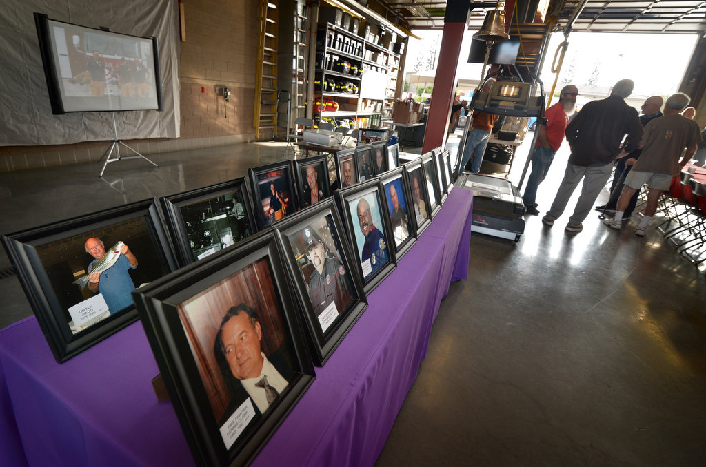 Photographs of Anaheim firefighters who passed away in the past year are lined up on a table during the Anaheim Fire & Rescue’s annual retiree breakfast at Station 6. Photo by Steven Georges/Behind the Badge OC