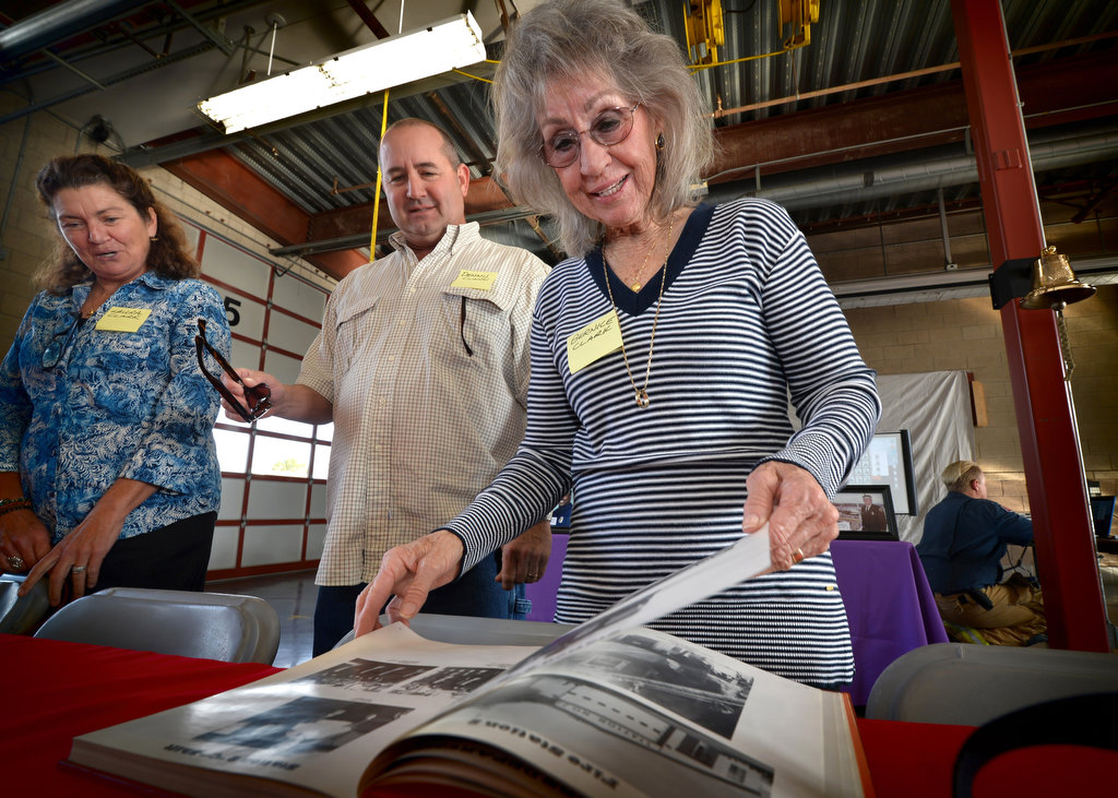Bernice Clark, right, wife of the late Anaheim Firefighter Dennis Clark who served from 1963-1987, looks through a book of old photographs of the department with Dennis’ daughter-in-law Laura Clark, left, and his son Dennis Clark. Photo by Steven Georges/Behind the Badge OC