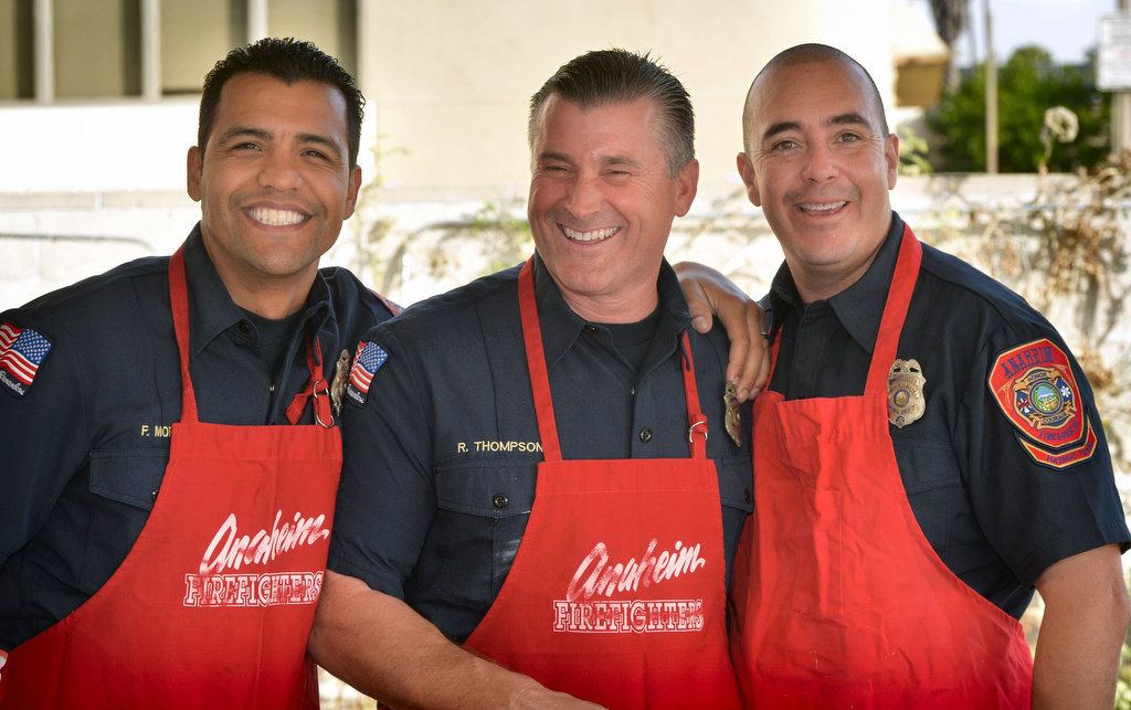 Anaheim Fire & Rescue fighters who are Hazmat Team members, Francisco Mora, left, Robert Thompson and Rick Romero team up to prepare breakfast for Anaheim fire retirees during the annual gathering. Photo by Steven Georges/Behind the Badge OC