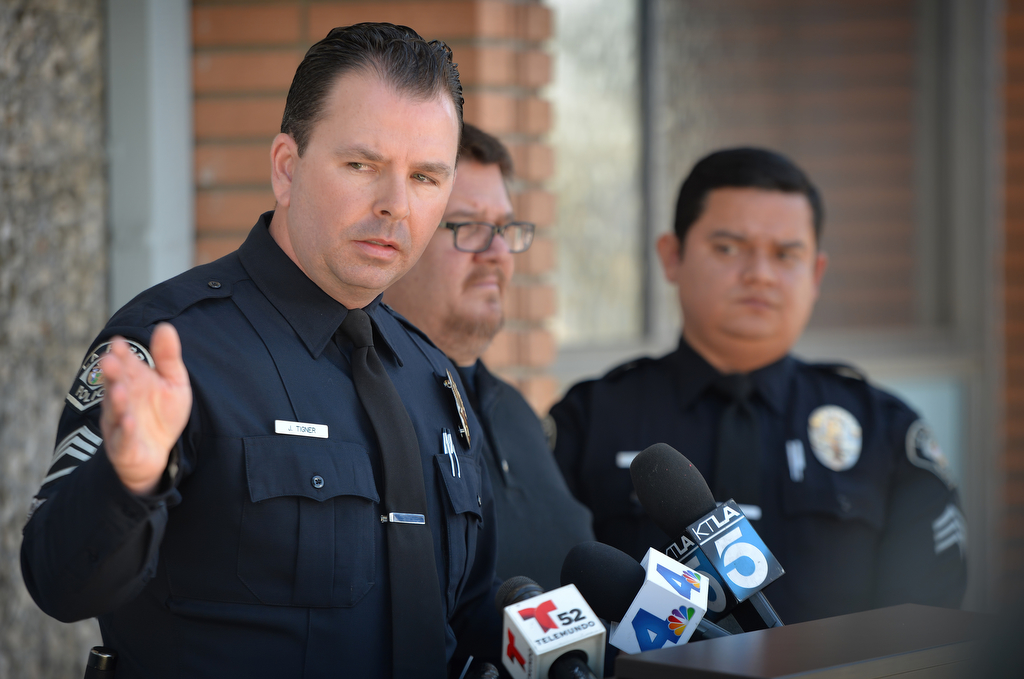 La Habra PD Sgt. Jim Tigner, left, answers questions during a press conference in front of the La Habra Police station announcing a $25,000 reward for information leading to the arrest & conviction of the hit and run driver who killed Linda May Lopez in La Habra on November 13, 2015. Behind him is family member Jayson Ramos and Sgt. Jose Rocha. Photo by Steven Georges/Behind the Badge OC