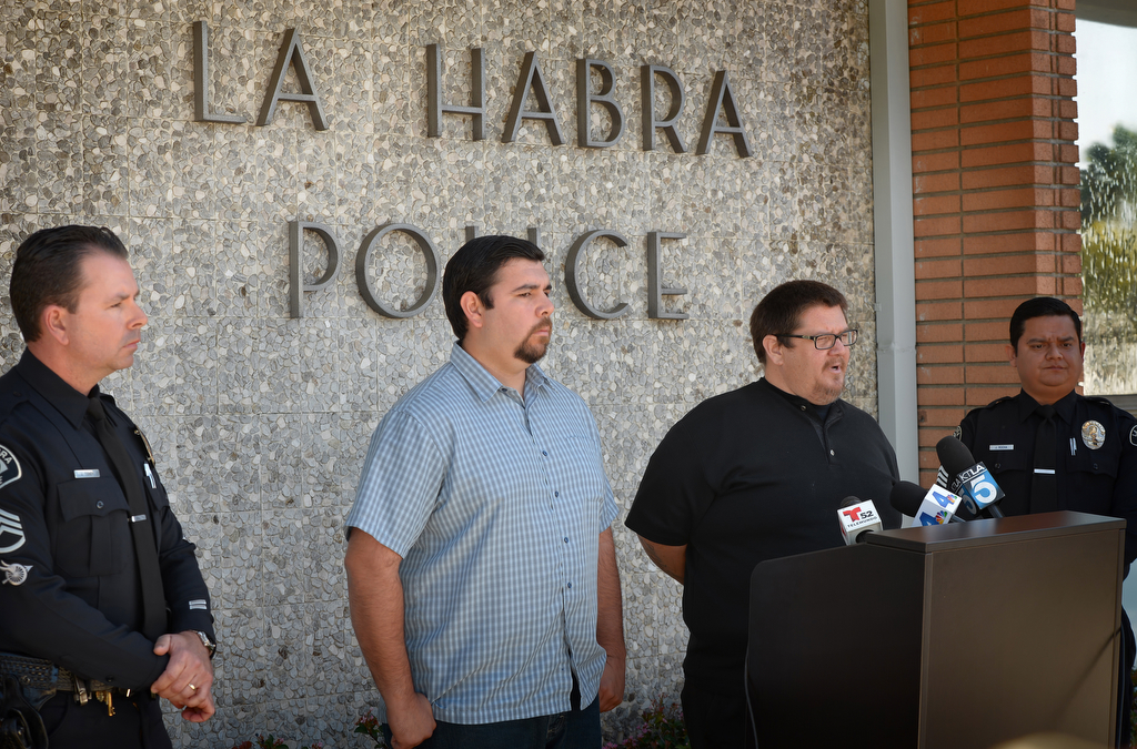 La Habra PD Sgt. Jim Tigner, left, family members C.J. Ramos, second from left, Jayson Ramos and Sgt. Jose Rocha announce a $25,000 reward for information leading to the arrest & conviction of the driver of the Toyota SUV that struck and killed Linda May Lopez in La Habra on November 13, 2015. Photo by Steven Georges/Behind the Badge OC