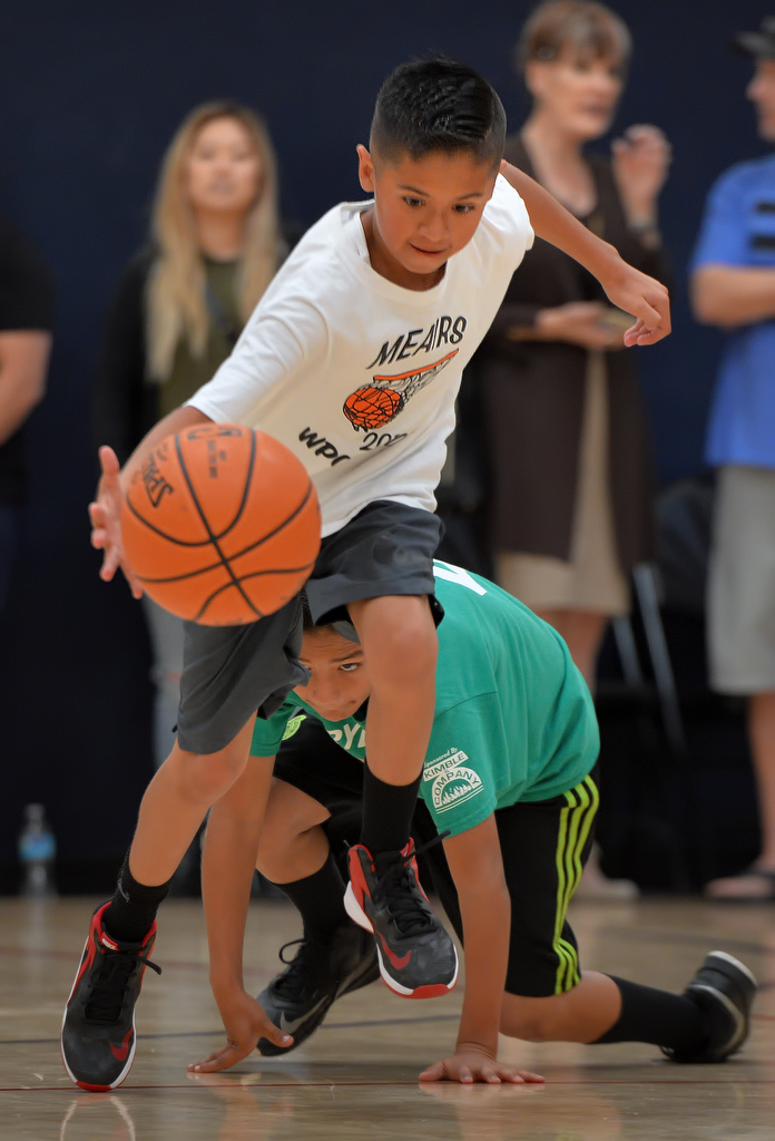 Robert Tapia of team Meairs runs with the ball during the WPOA Hoops Basketball League tournament at the Boys & Girls Club of Westminster. Photo by Steven Georges/Behind the Badge OC