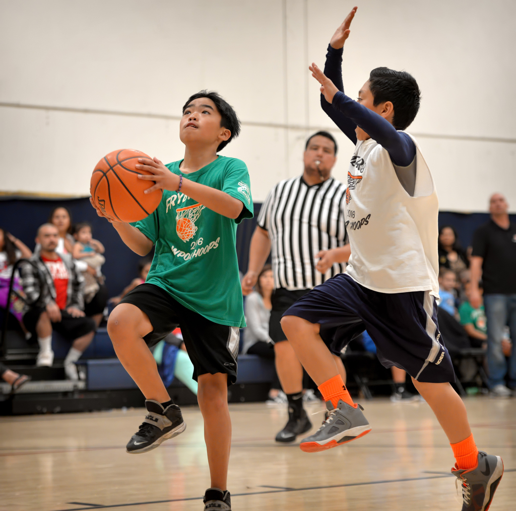 Kids compete in the Hoops Basketball League championship game at the Boys & Girls Club of Westminster sponsored by the Westminster Police Officer's Association. Photo by Steven Georges/Behind the Badge OC
