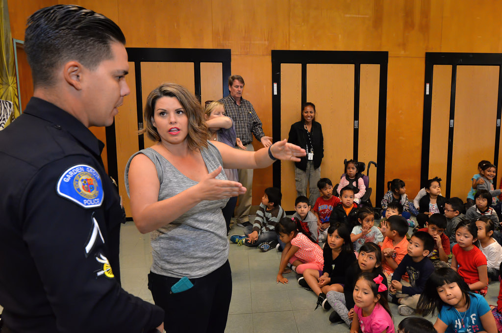 Anderson Elementary First Grade Teacher Bobbie Weber talks to her brother, Garden Grove Motorcycle Officer Royce Wimmer during a school assembly on bicycle safety. Photo by Steven Georges/Behind the Badge OC