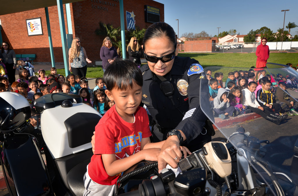 Six-year-old Tony Ho of Anderson Elementary checks out Garden Grove PD Officer Kathy Anderson’s police motorcycle during a visit to the Garden Grove school. Photo by Steven Georges/Behind the Badge OC