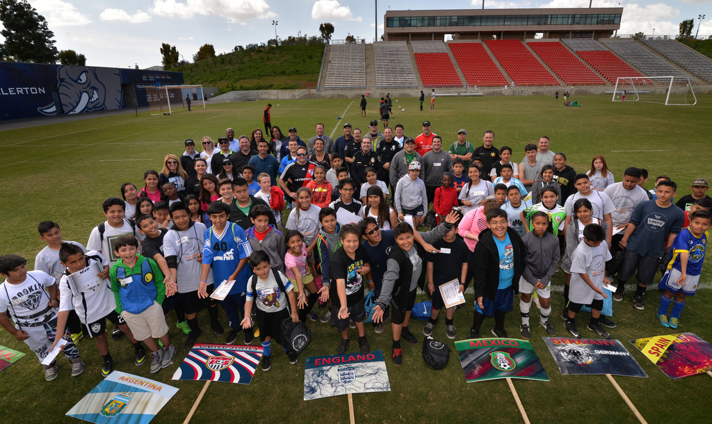 Players who participated on the OC GRIP soccer camp gather for one last photo with coaches and police at the Cal State Fullerton soccer stadium. Photo by Steven Georges/Behind the Badge OC