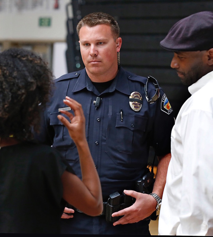 Tustin PD Sgt. Ryan Coe talks with Tustin High student Linda McNeil and her father Adama Sirleaf after the final assembly. Photo by Christine Cotter/Behind the Badge OC. 