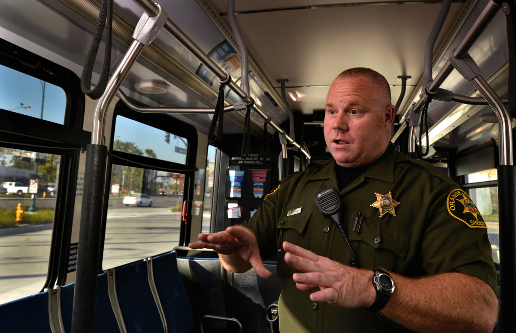 Orange County Deputy Sheriff Chad Smith of the Transit Police Services talks about the transit beat while inside an OCTA bus in Anaheim. Photo by Steven Georges/Behind the Badge OC