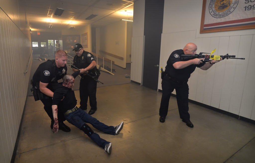 La Habra PD officers remove the acting wounded and clear the hallway during an active shooter drill at Sonora High School. Photo by Steven Georges/Behind the Badge OC