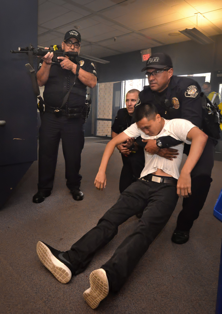 La Habra PD Officer Eliseo Funes removes people acting as the wounded during an active shooter drill at Sonora High School. Photo by Steven Georges/Behind the Badge OC