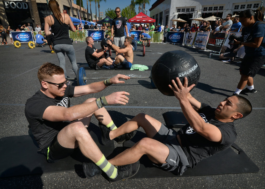 Manny Adams, left, and Calvin Bui of Anaheim Fire & Rescue’s team Rookie and the WannaB competes in the 2nd Annual APD Guns N Hoses Fitness Competition. Photo by Steven Georges/Behind the Badge OC