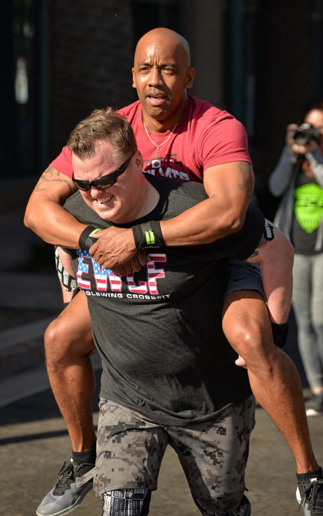 Anaheim PD Lt. Eric Trapp caries Lt. Lorenzo Glenn during the 2nd Annual APD Guns N Hoses Fitness Competition. Photo by Steven Georges/Behind the Badge OC