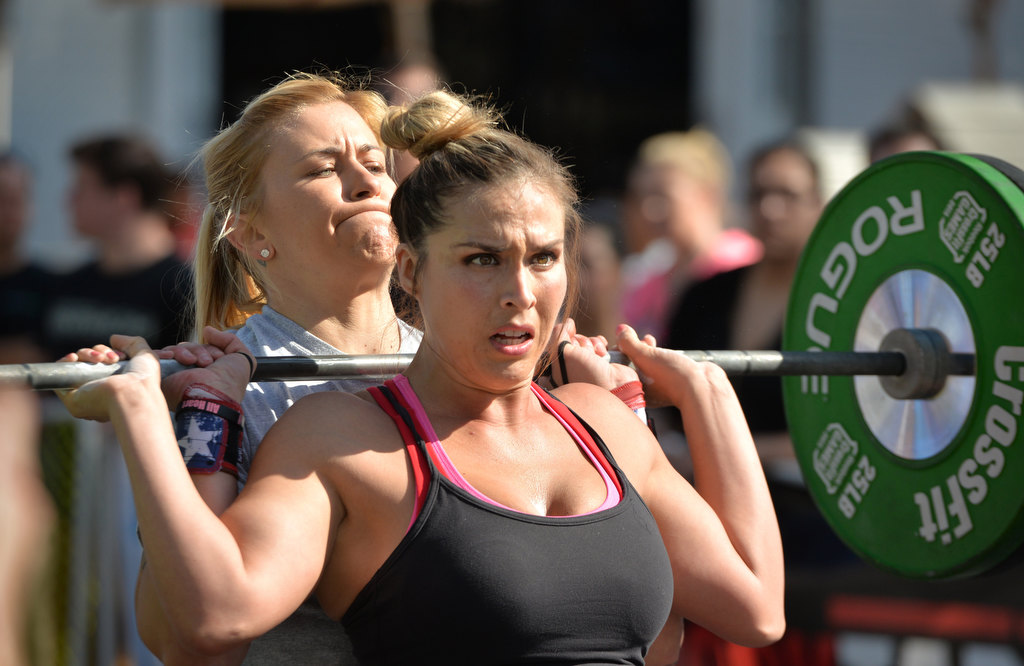 Melisa Nelson of Anaheim PD’s team For Him Gear, front, passes the weights to Merisa Leatherman during the 2nd Annual APD Guns N Hoses Fitness Competition. Photo by Steven Georges/Behind the Badge OC