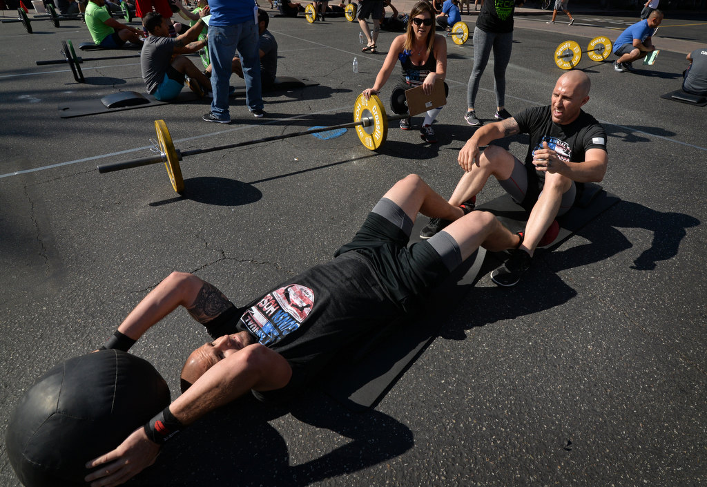 Anaheim PD’s Ryan Killeen, left, and Rory Rexroad of Murrieta Fire, team Norco Boys, compete in the 2nd Annual APD Guns N Hoses Fitness Competition. Photo by Steven Georges/Behind the Badge OC