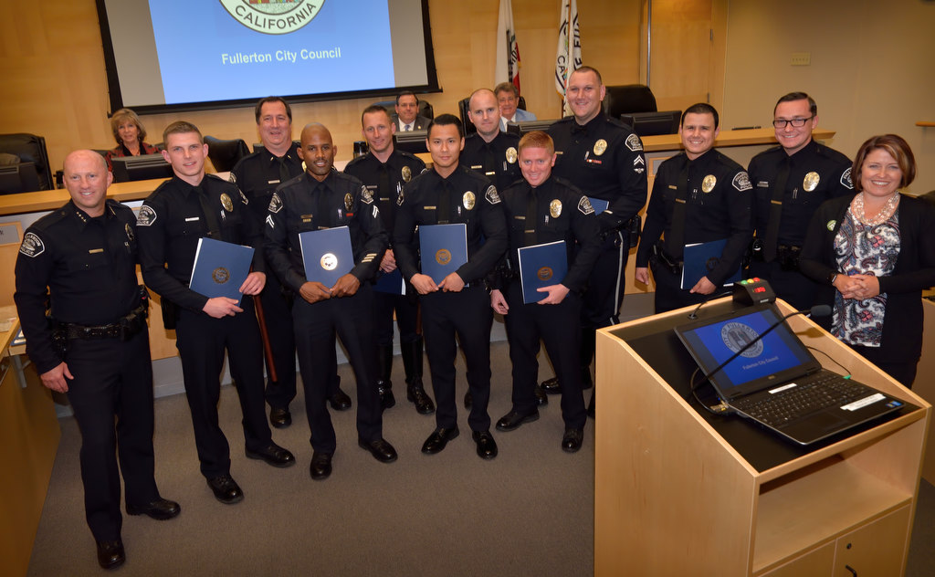 Recognizing Fullerton police officers at a city council meeting for their efforts in curbing drunken and drugged, Fullerton Police Chief Dan Hughes, left, Lt. Mike Chlebowski, third from left, and Mayor Jennifer Fitzgerald, right, present a DUI pin to Michael Halverson, second from left, Eric Bridges, Ryan Warner, Denny Bak, Scott Flynn, Joshua Manes, Kyle Baas, Jonathan Munoz and Nicholas Dempkowski. Unable to attend was Timothy Gibert. Photo by Steven Georges/Behind the Badge OC