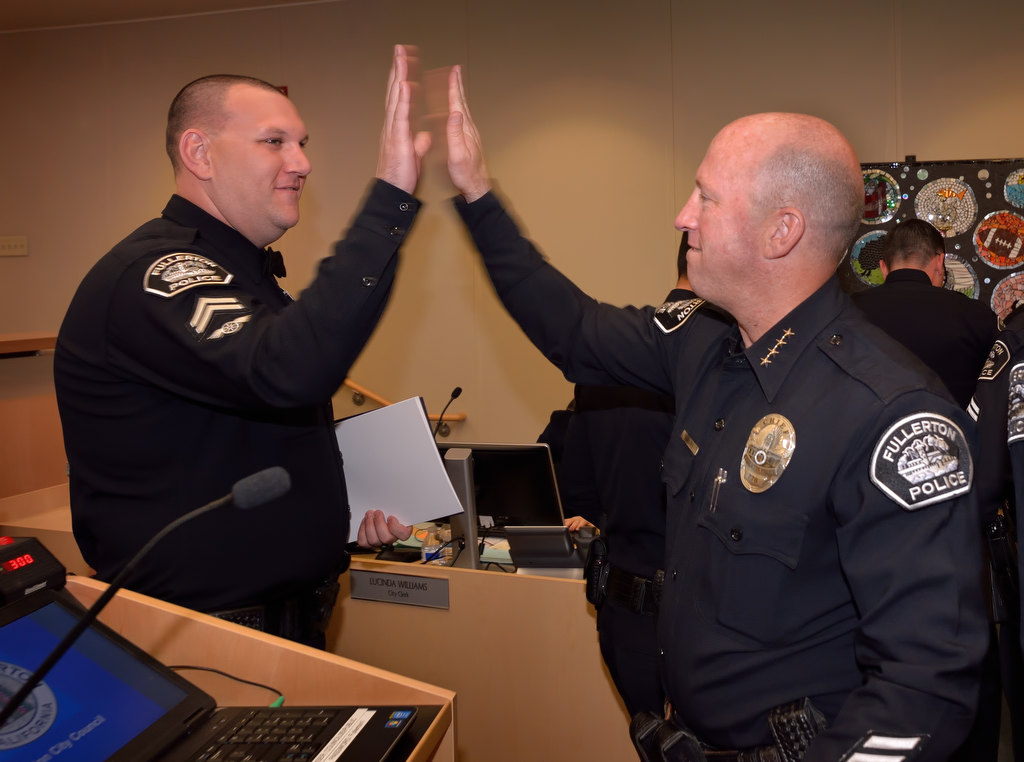 Fullerton PD Cpl. Kyle Baas gets a high-five from Fullerton Police Chief Dan Hughes as the chief congratulates his officers for their efforts in fighting drunken and drugged driving. Photo by Steven Georges/Behind the Badge OC