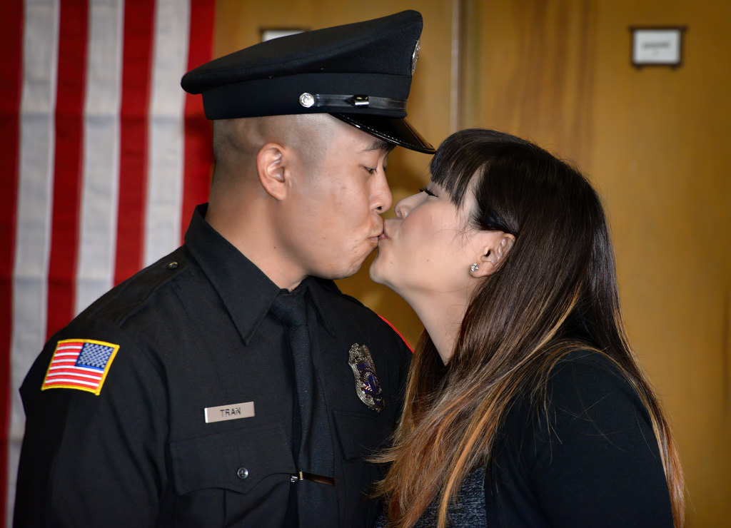 Fullerton Firefighter Christopher Tran gets a kiss after receiving his new badge during the Fullerton Fire Department’s promotional ceremony. Photo by Steven Georges/Behind the Badge OC