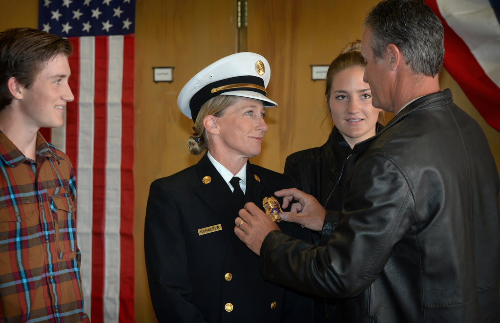 Fullerton/Brea Battalion Chief Kathy Schaefer has her new badge pinned on her by her family during the Fullerton Fire Department’s promotional ceremony. Photo by Steven Georges/Behind the Badge OC