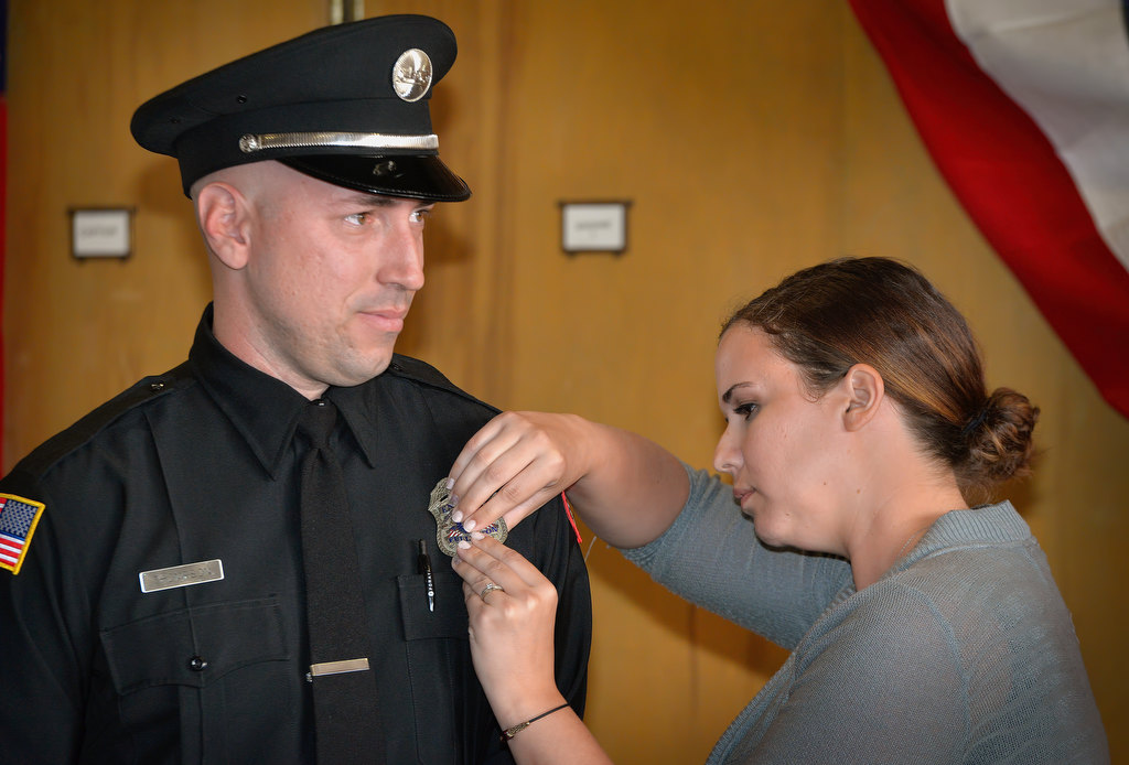 Fullerton Engineer Robert Thompson gets his new badge pinned to him during the Fullerton Fire Department’s promotional ceremony. Photo by Steven Georges/Behind the Badge OC