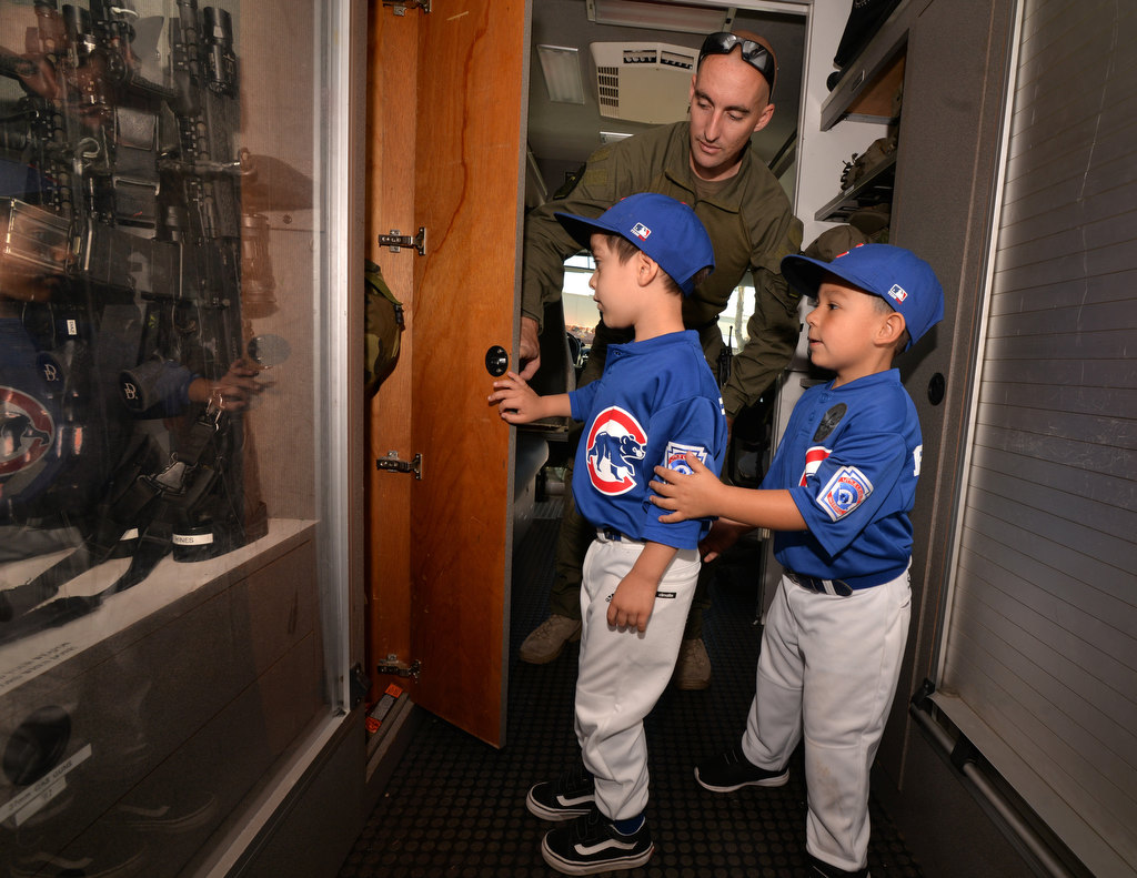 Fullerton PD Officer Mike Greene gives Blake Ramirez, 4, of Anaheim, left, and Vincent Bautista, 5, of Fullerton, a tour of Fullerton PDÕs Special Weapons and Tactics truck during the Shoot Or DonÕt Shoot Law Enforcement Challenge at Tac City Airsoft in Fullerton. Photo by Steven Georges/Behind the Badge OC