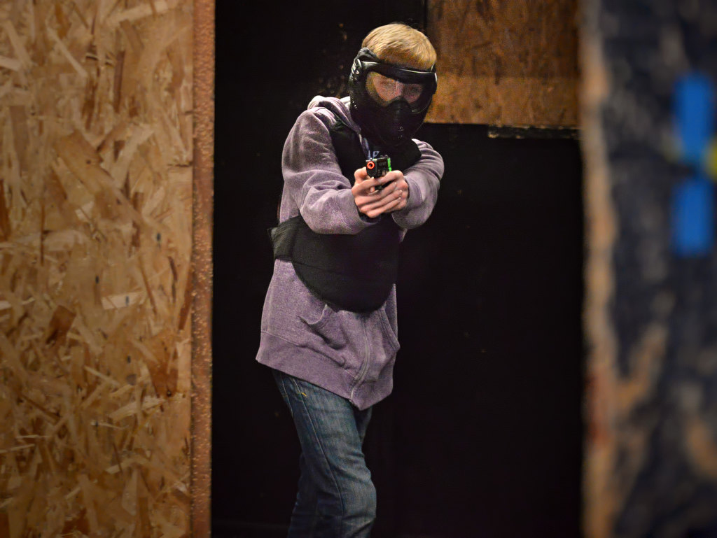 Jacob Vanover, 14, of Anaheim, comes around the corner as he walks through the Shoot Or DonÕt Shoot Law Enforcement Challenge at Tac City Airsoft in Fullerton. The face masks are used to protect the eyes and face from the plastic pellets used as ammunition in the maze. Photo by Steven Georges/Behind the Badge OC