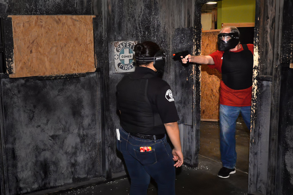Thomas Hession of Anaheim, right, shoots the bad guy, out of the frame, while not shooting the victim in front of him, a Buena Park PD Explorer, during the Shoot Or DonÕt Shoot Law Enforcement Challenge at Tac City Airsoft in Fullerton. Hession came to the event with his daughter for her birthday. Photo by Steven Georges/Behind the Badge OC