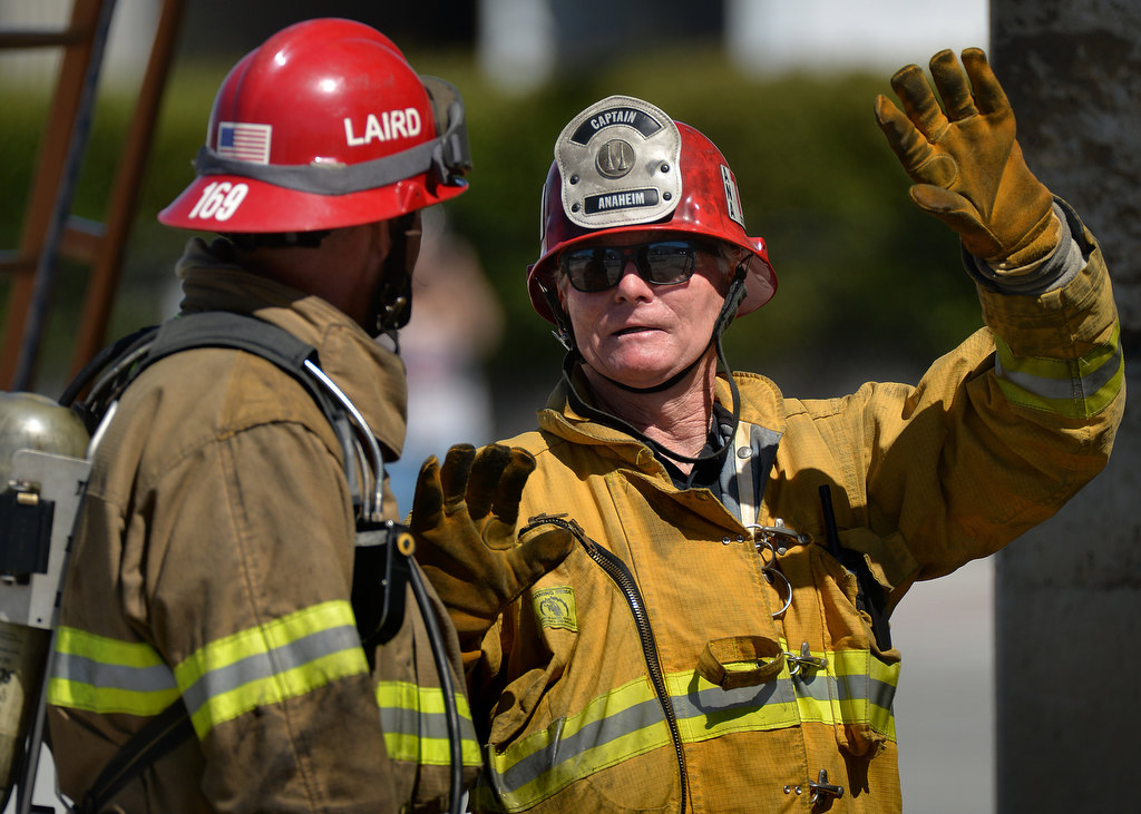 Bill Stroud of Anaheim Fire & Rescue, right, works with recruits at Central Net on his last day as a fire instructor. Photo by Steven Georges/Behind the Badge OC