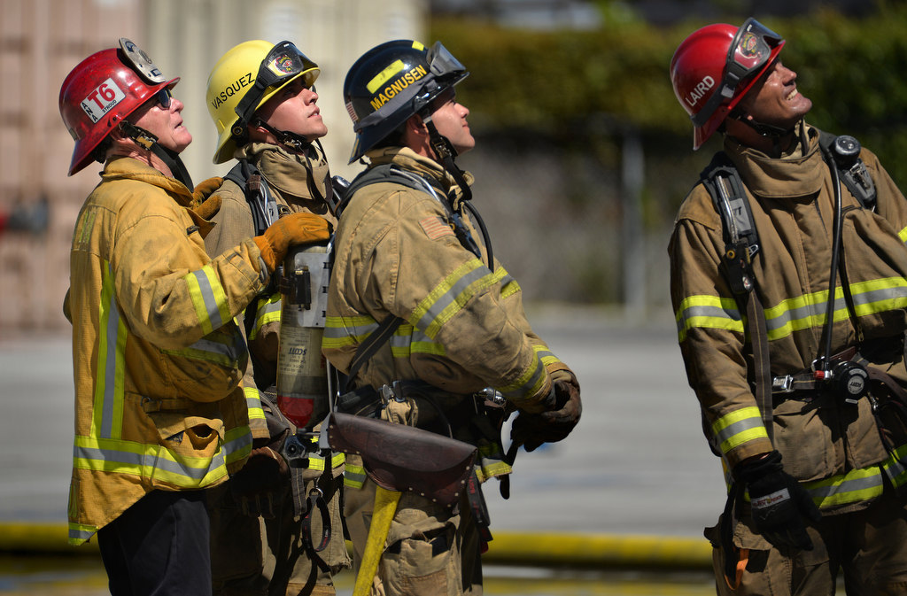Bill Stroud of Anaheim Fire & Rescue, left, works with recruits at Central Net on his last day as a fire instructor. Photo by Steven Georges/Behind the Badge OC