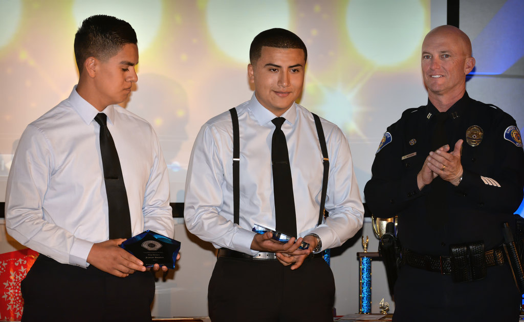 Capt. Travis Whitman, right, applauds as Jason Brito left, and Luis Quiroz receive the Top Honors award during the Garden Grove Police Explorers awards banquet. Quiroz also received the Most Improved award. Photo by Steven Georges/Behind the Badge OC