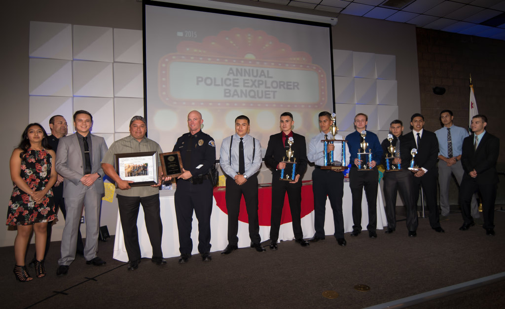 Officer Lino Santana, forth from left, is presented with the Advisor of the Year award as he stands on stage with those explorers involved with the Chandler Tactical Competition in Arizona. Photo by Steven Georges/Behind the Badge OC