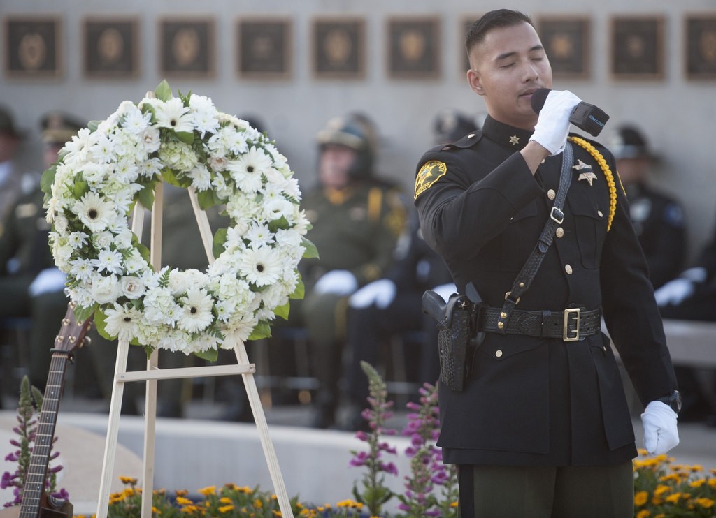 Orange County Sheriff's Deputy Joe Devela sings "You Raise Me Up" during the 2016 Orange County Peace Officers' Memorial Ceremony and Candlelight Vigil held at the OCSD Regional Training Facility.