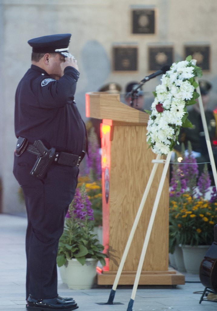 Los Alamitos Police Chief Eric Nunez salutes after placing a rose in the wreath at the 2016 Orange County Peace Officers' Memorial Ceremony and Candlelight Vigil held at the OCSD Regional Training Facility.