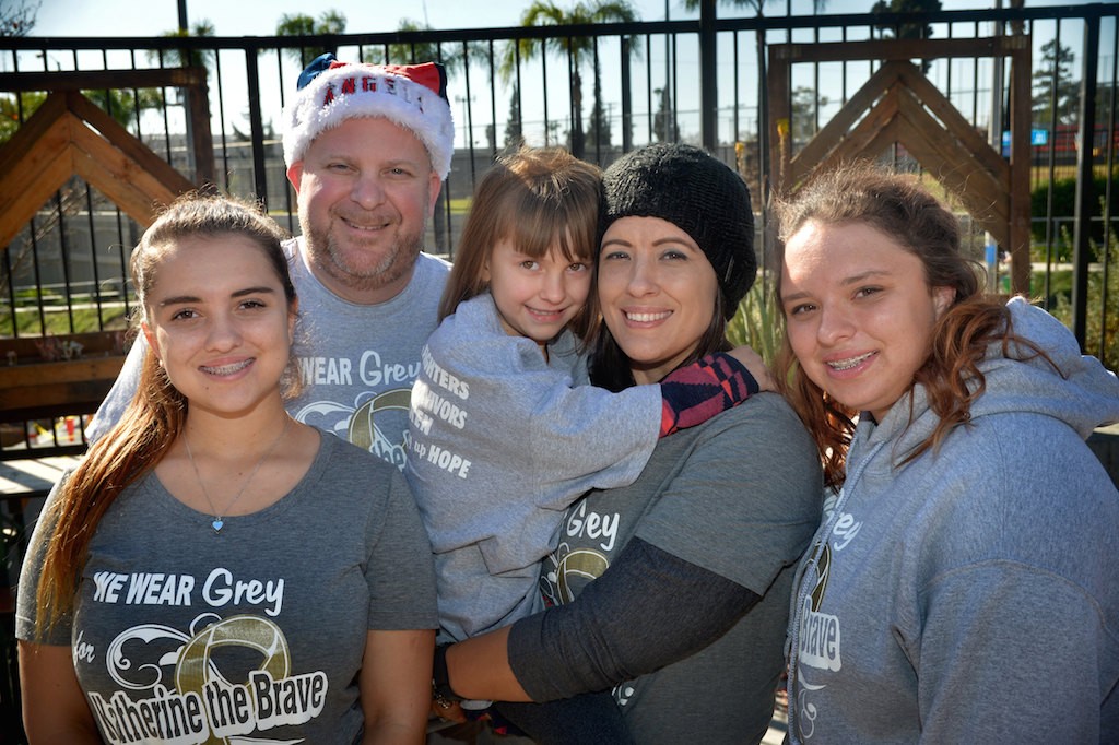 Six-year-old Katherine King, center, who was diagnosed with Diffuse Pontine Intrinsic Glioma (DIPG), an inoperable and incurable brain stem tumor, with her family, Alissa LaShorne, sister, left, David King, dad, Katherine, Jaimee King, mom, and Tori LaShorne, sister, at Bootlegger’s Brewery and the Clothes for the Cause fundraiser. Photo by Steven Georges/Behind the Badge OC