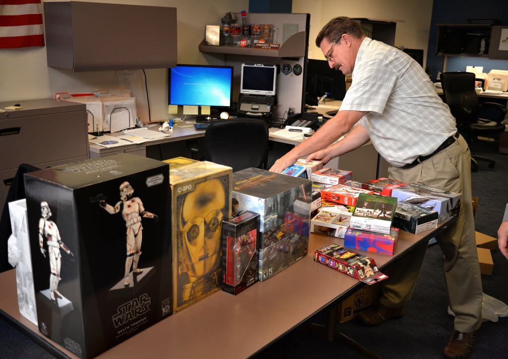 Anaheim Det. Dave Hermann catalogs and pack items suspected of being stolen from a warehouse and confiscated by Anaheim PD during a sting operation. Photo by Steven Georges/Behind the Badge OC