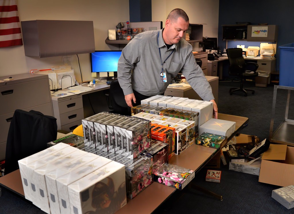 Det. Jason Sivgals catalogs and pack items suspected of being stolen from a warehouse and confiscated by Anaheim PD during a sting operation. Photo by Steven Georges/Behind the Badge OC
