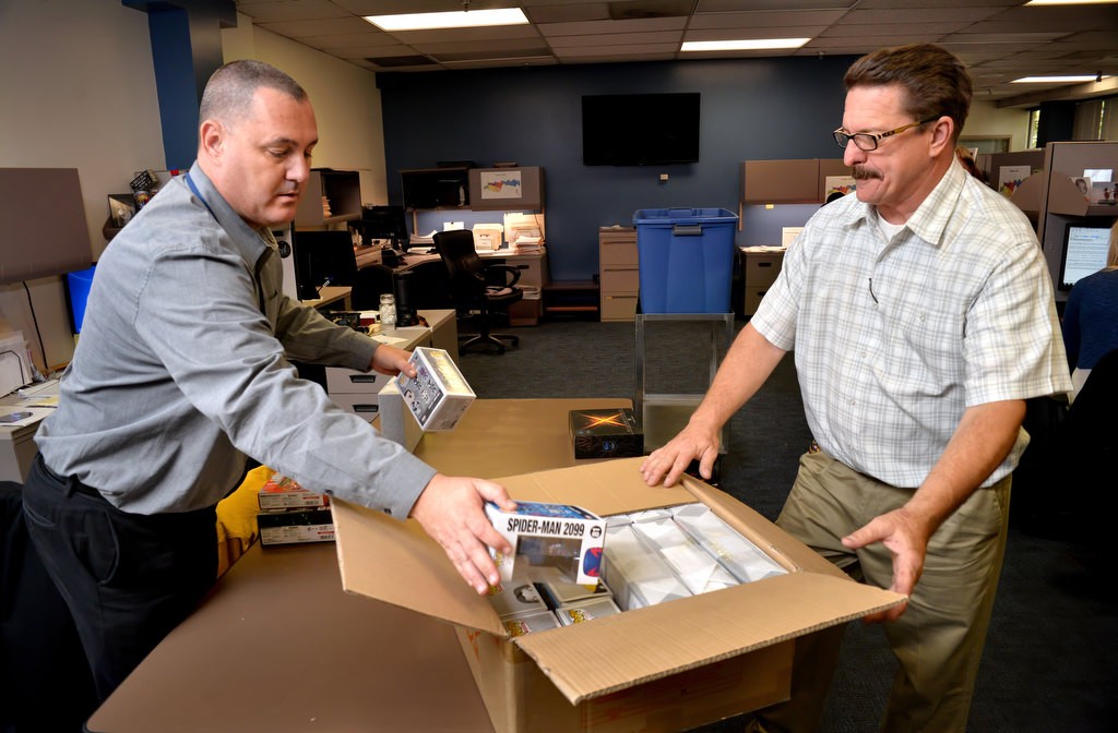 Anaheim PD detectives Jason Sivgals, left, and Dave Hermann catalog and pack items suspected of being stolen from a warehouse and confiscated by Anaheim PD during a sting operation. Photo by Steven Georges/Behind the Badge OC