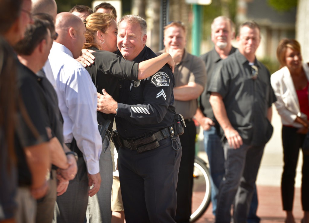 Fullerton PD Cpl. Matt Malone gets a hug from Det. Carin Wright (Cpl.) during the Walk of Honor at Fullerton Police Headquarters. Photo by Steven Georges/Behind the Badge OC