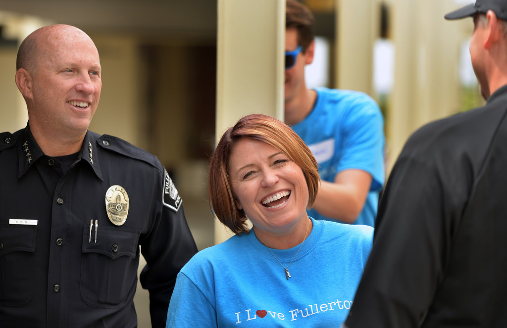 Fullerton Police Chief Dan Hughes and Mayor Jennifer Fitzgerald talk to volunteers working to improve Sunny Hills High during the Love Fullerton community event. Photo by Steven Georges/Behind the Badge OC